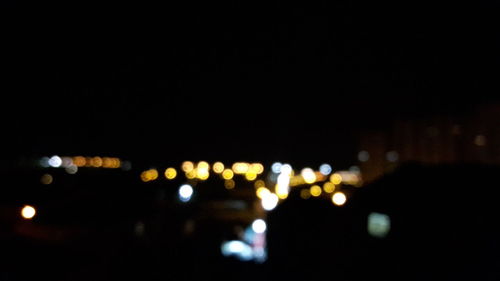 Defocused image of illuminated city at night