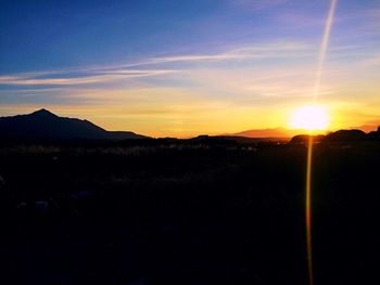 Scenic view of silhouette mountains against sky during sunset