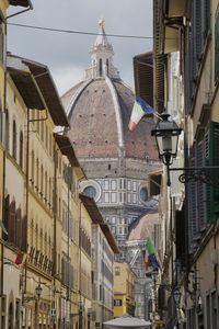 Low angle view through a narrow old town street to the cathedral of florence, italy.