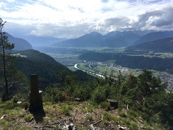 Scenic view of landscape and mountains against sky