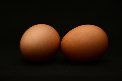 Close-up of eggs against black background