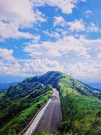 Road leading towards mountains against sky