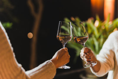 Woman hand clicking glasses of wine celebration concept.