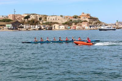 People rowing in the sea