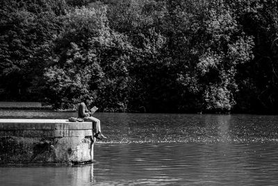 Man sitting by lake