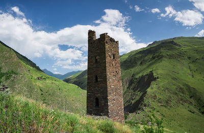 Built structure on landscape against sky