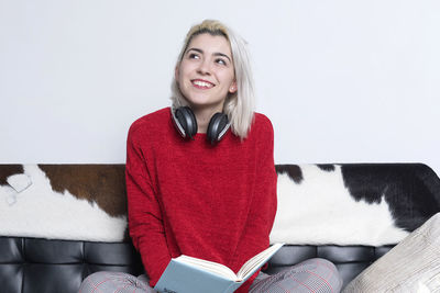 Portrait of young woman using laptop at home