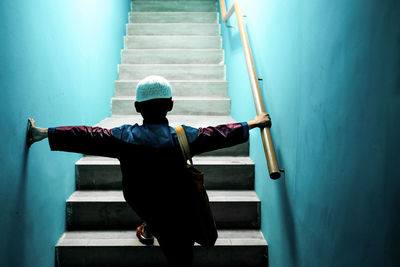 Rear view of boy walking on steps