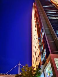 Low angle view of buildings against clear sky at night