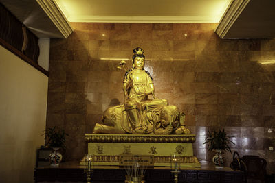 Low angle view of statue against ceiling