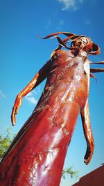 Low angle view of insect against blue sky