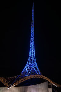 Low angle view of illuminated tower against sky at night