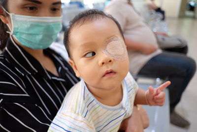 Close-up of baby boy with bandage on eye