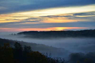 Scenic view of silhouette trees against sky during sunset