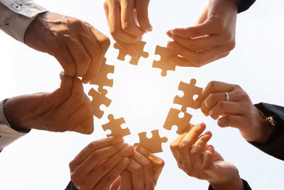 Cropped hand of person holding jigsaw puzzle