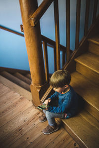 Full length of cute boy on wooden floor