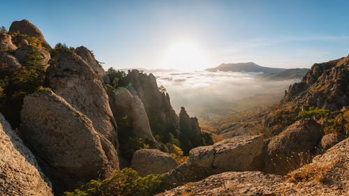 Panoramic view of rocks and mountains against sky