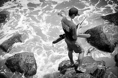 Young woman jumping on rock