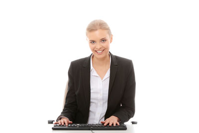 Portrait of a smiling young woman against white background