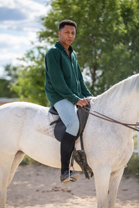 Portrait of man riding horse