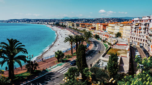 High angle view of street by buildings against sky