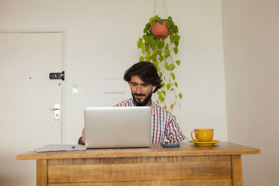 Young business man working  with laptop. gray notebook for working. home office