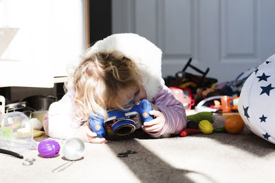 Girl playing with toys on rug at home