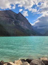 Scenic view of lake and mountains against sky