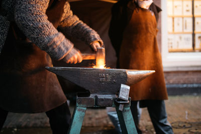 Midsection of worker working in factory