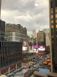 High angle view of city street and buildings against sky