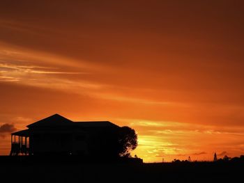 Silhouette buildings against sky during sunset