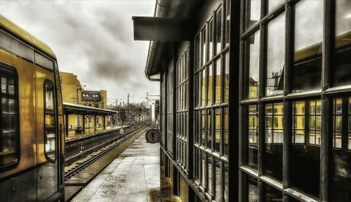 Train at railroad station against sky