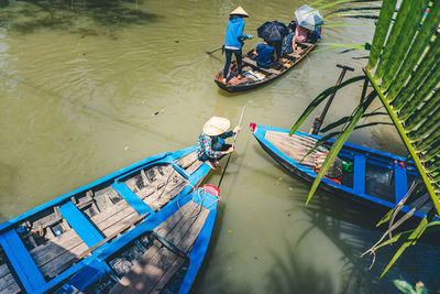 High angle view of people on boat moored in river