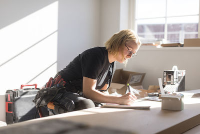 Woman drawing plan during house renovation