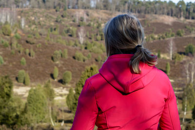 Rear view of woman standing on tree