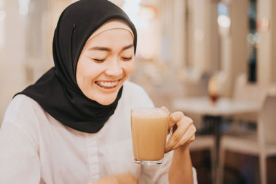 Portrait of a beautiful young woman drinking coffee