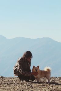 View of a dog on mountain against clear sky