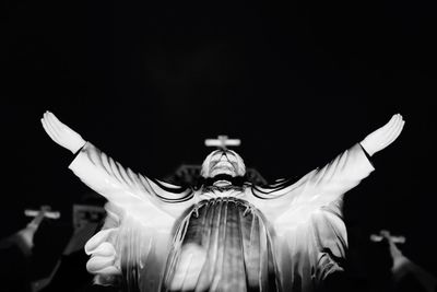 Close-up of statue against black background