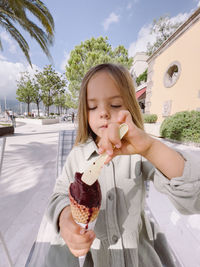 Portrait of young woman holding ice cream cone