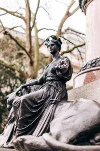 Low angle view of statue against trees