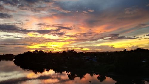 Scenic view of lake against romantic sky at sunset