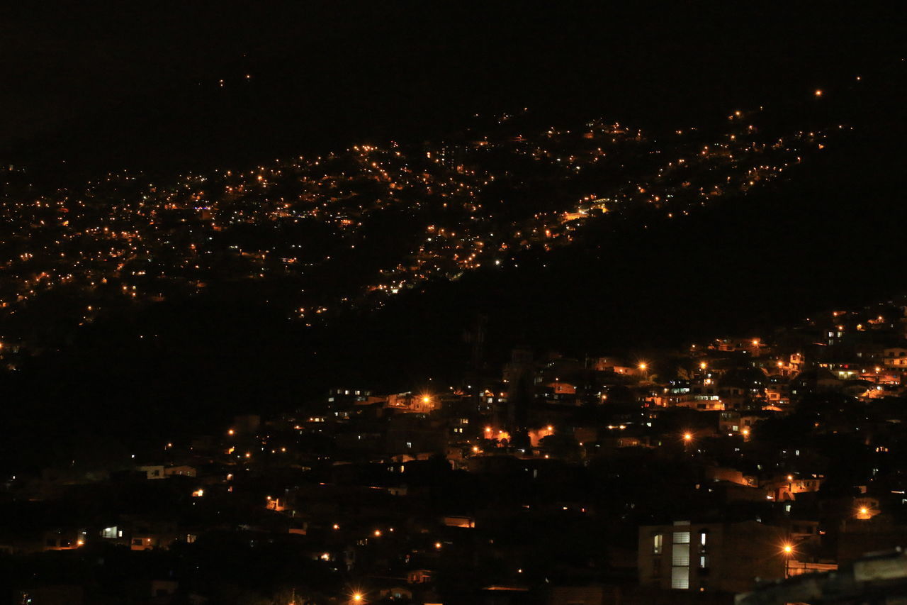 HIGH ANGLE VIEW OF ILLUMINATED BUILDINGS IN CITY