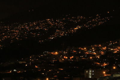 High angle view of illuminated buildings in city at night