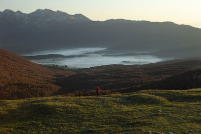 Scenic view of landscape and mountains against sky