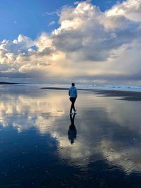 Rear view of man standing on beach