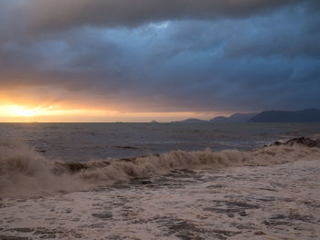 Scenic view of sea against dramatic sky