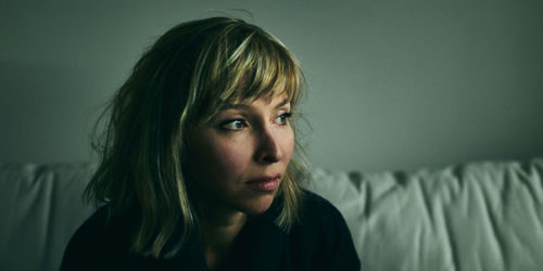 Portrait of young woman looking away at home