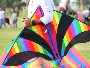 Midsection of man with umbrella