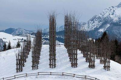 Panoramic view of snow covered field against sky