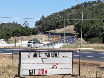 Text on road against clear sky